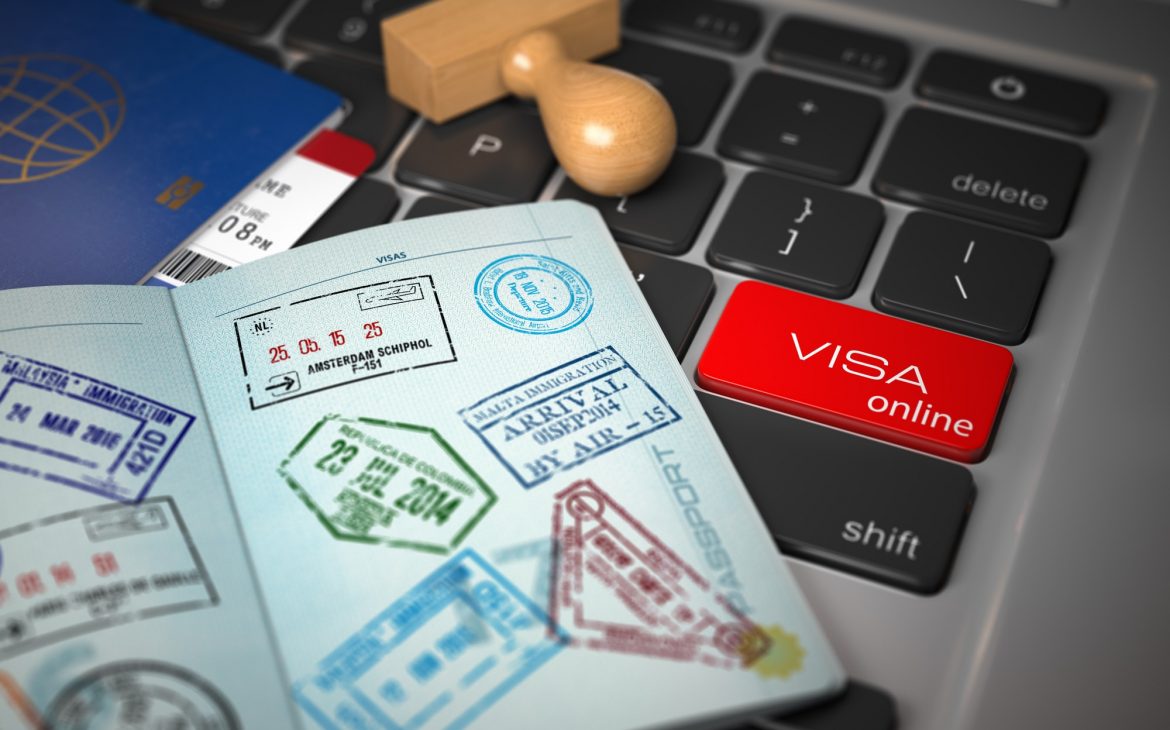 Visa online application concept. Open passport with visa stamps